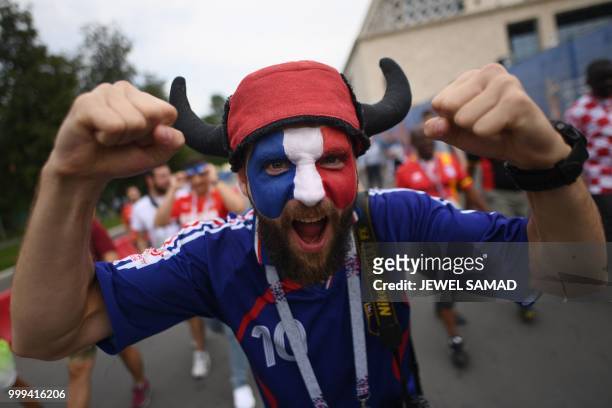 France supporter cheers ahead of the Russia 2018 World Cup final football match between France and Croatia at the Luzhniki Stadium in Moscow on July...