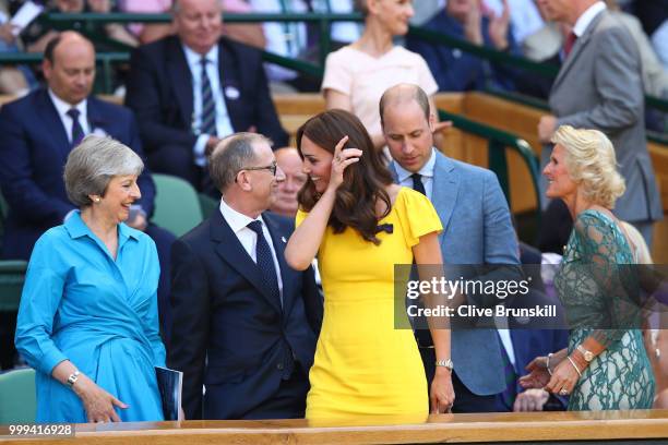 Catherine, Duchess of Cambridge and Prince William, Duke of Cambridge pass British Prime Minister Theresa May and her husband Philip May as they...