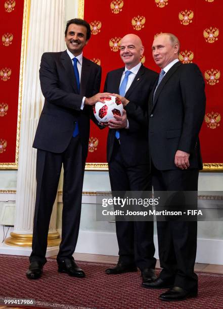 Amir of Qatar Sheikh Tamim bin Hamad Al Thani, FIFA president Gianni Infantino and President of Russia Valdimir Putin participate in a handover...