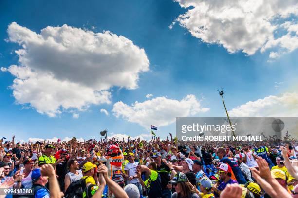Spanish Honda rider Marc Marquez celebrates with supporters after winning the Moto GP race at the Grand Prix of Germany at the Sachsenring Circuit on...