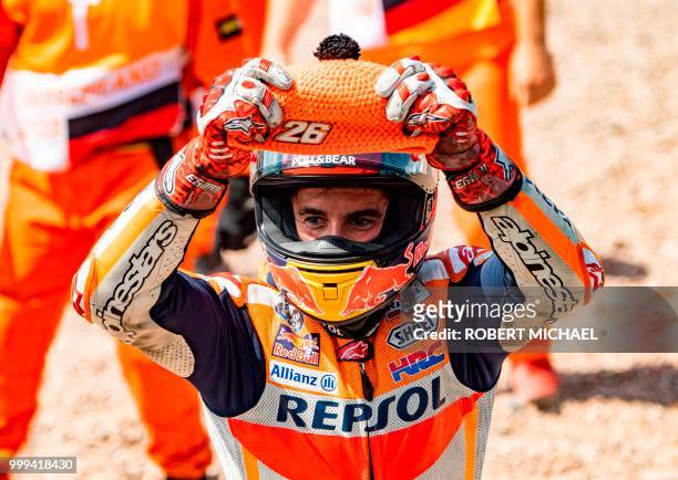 Spanish Honda rider Marc Marquez celebrates after winning the Moto GP race at the Grand Prix of Germany at the Sachsenring Circuit on July 15, 2018...