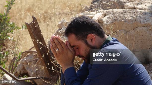 Syrian citizen is seen as he waits to leave Syrias southwestern Daraa province with the 1st convoy on July 15, 2018. The convoy of 15 buses carried...