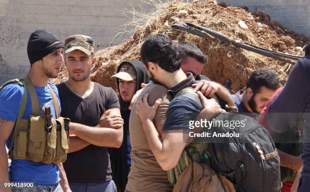 Syrian citizens say goodbye to each other as they leave Syrias southwestern Daraa province with the 1st convoy on July 15, 2018. The convoy of 15...