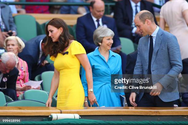 Catherine, Duchess of Cambridge and Prince William, Duke of Cambridge pass British Prime Minister Theresa May as they attend the Men's Singles final...