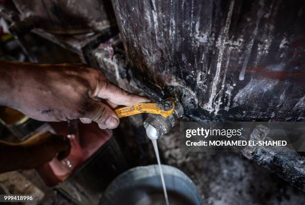 An Egyptian labourer works at a shop specialized in seashell wood inlays in the Saqyat al-Manqadi village in the Egyptian Nile Delta province of...