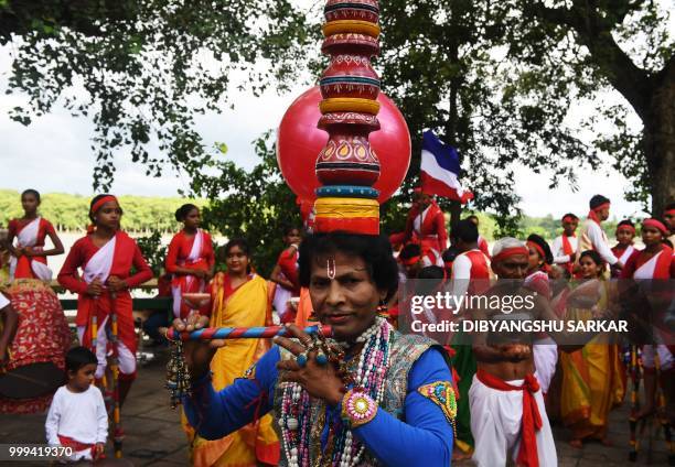 Indian traditional folk dancers perform to show their support to the French football team ahead of the FIFA 2018 World Cup final match in the French...