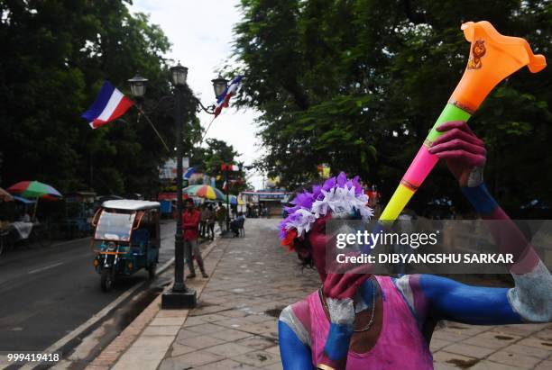 An Indian fan of the French football team celebrates to show his suuport ahead of the FIFA 2018 World Cup final match in the French colonial town of...
