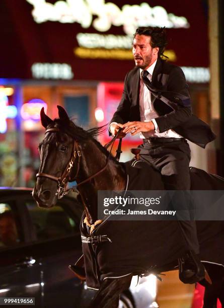 Keanu Reeves seen riding a horse on location for 'John Wick 3' in Brooklyn on July 14, 2018 in New York City.