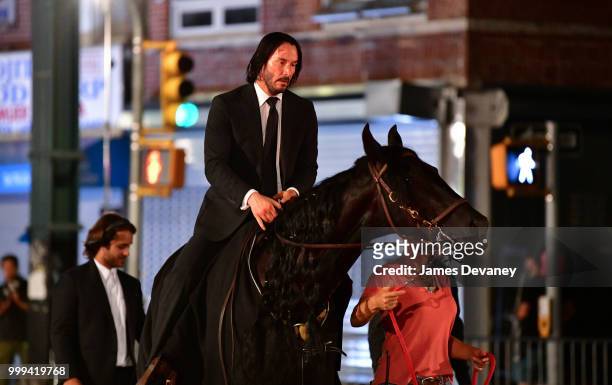 Keanu Reeves seen riding a horse on location for 'John Wick 3' in Brooklyn on July 14, 2018 in New York City.