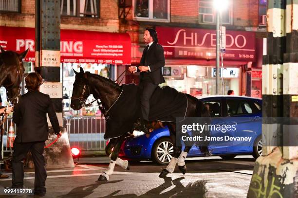 Keanu Reeves seen riding a horse on location for 'John Wick 3' in Brooklyn on July 14, 2018 in New York City.