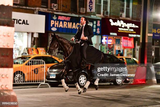 Keanu Reeves seen riding a horse on location for 'John Wick 3' in Brooklyn on July 14, 2018 in New York City.