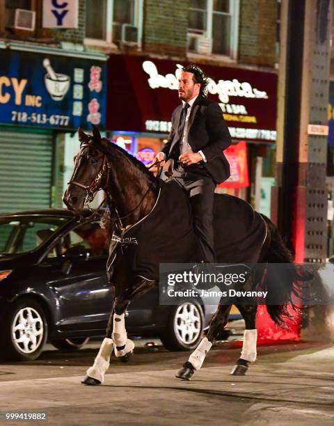 Keanu Reeves seen riding a horse on location for 'John Wick 3' in Brooklyn on July 14, 2018 in New York City.