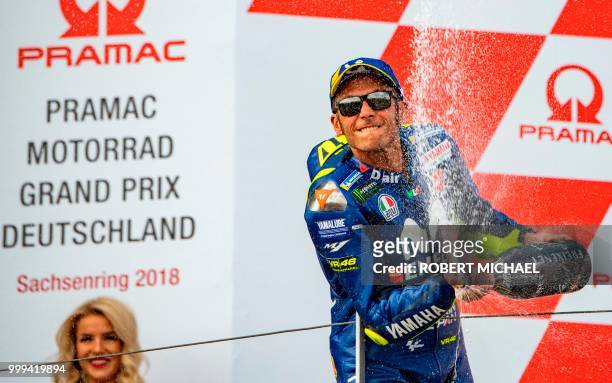 Second placed Italian Yamaha rider Valentino Rossi celebrates on the podium after winning the Moto GP race at the Grand Prix of Germany at the...