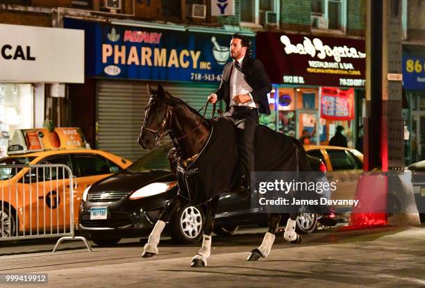 Keanu Reeves seen riding a horse on location for 'John Wick 3' in Brooklyn on July 14, 2018 in New York City.