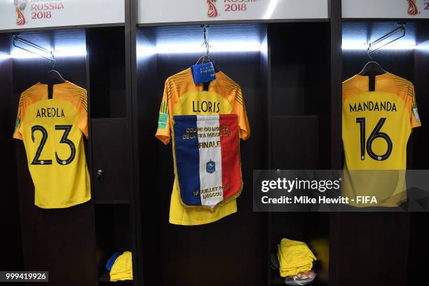 Alphonse Areola, Steve Mandanda and Hugo Lloris of France's shirts are seen alongside the France pennant inside the France dressing room prior to the...