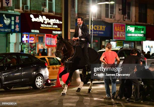 Keanu Reeves seen riding a horse on location for 'John Wick 3' in Brooklyn on July 14, 2018 in New York City.