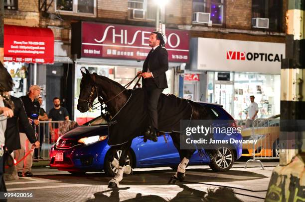 Keanu Reeves seen riding a horse on location for 'John Wick 3' in Brooklyn on July 14, 2018 in New York City.