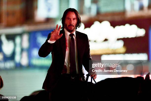 Keanu Reeves seen riding a horse on location for 'John Wick 3' in Brooklyn on July 14, 2018 in New York City.