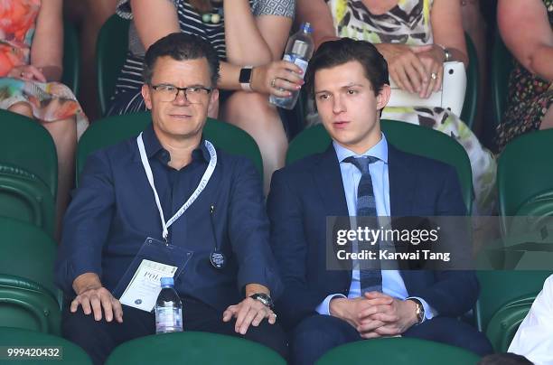 Tom Holland and his father Dominic Holland attend the men's singles final on day thirteen of the Wimbledon Tennis Championships at the All England...