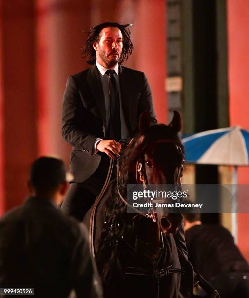 Keanu Reeves seen riding a horse on location for 'John Wick 3' in Brooklyn on July 14, 2018 in New York City.