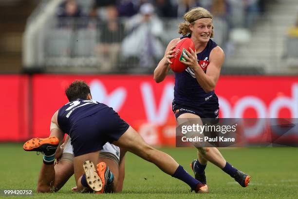 Stefan Giro of the Dockers looks to pass the ball during the round 17 AFL match between the Fremantle Dockers and the Port Adelaide Power at Optus...