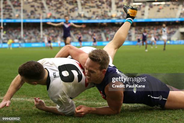 Ryan Nyhuis of the Dockers tackles Robbie Gray of the Power during the round 17 AFL match between the Fremantle Dockers and the Port Adelaide Power...