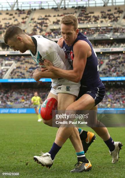Ryan Nyhuis of the Dockers tackles Robbie Gray of the Power during the round 17 AFL match between the Fremantle Dockers and the Port Adelaide Power...