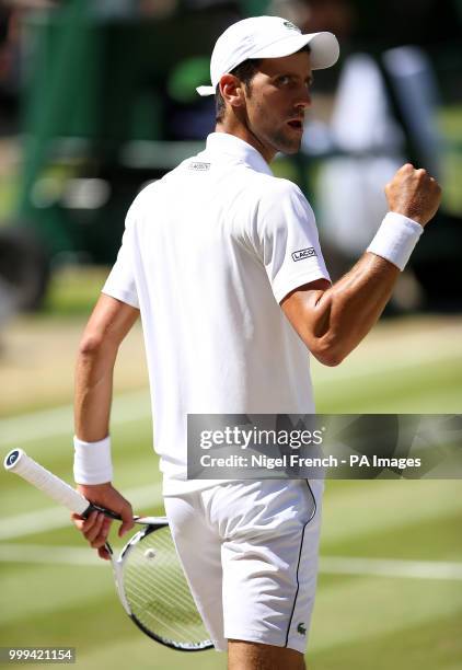 Novak Djokovic celebrates breaking the serve of Kevin Anderson in the first set on day thirteen of the Wimbledon Championships at the All England...