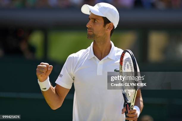Serbia's Novak Djokovic celebrates winning the first set against South Africa's Kevin Anderson in their men's singles final match on the thirteenth...
