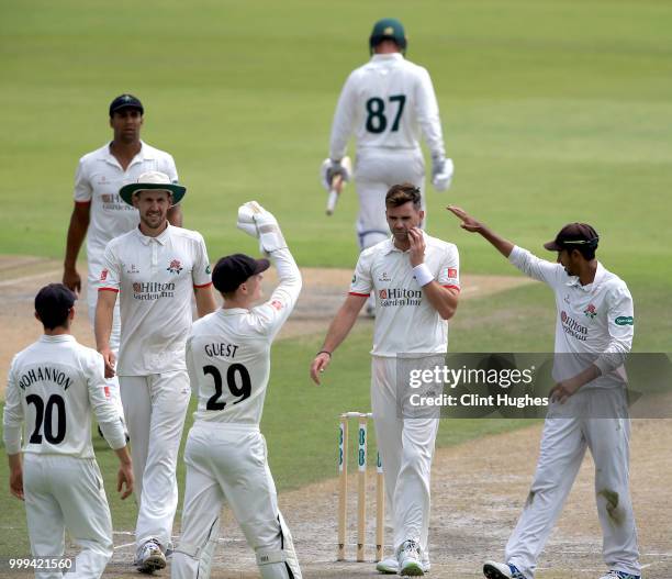 James Anderson of Lancashire celebrates with his team-mates after taking the wicket of Liam Patterson-White of Nottinghamshire during the Lancashire...