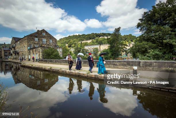 Steampunks are reflected in the River Calder during the Hebden Bridge Steampunk Festival in West Yorkshire.