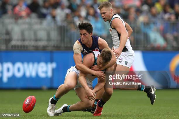 Adam Cerra of the Dockers tackles Ollie Wines of the Power during the round 17 AFL match between the Fremantle Dockers and the Port Adelaide Power at...