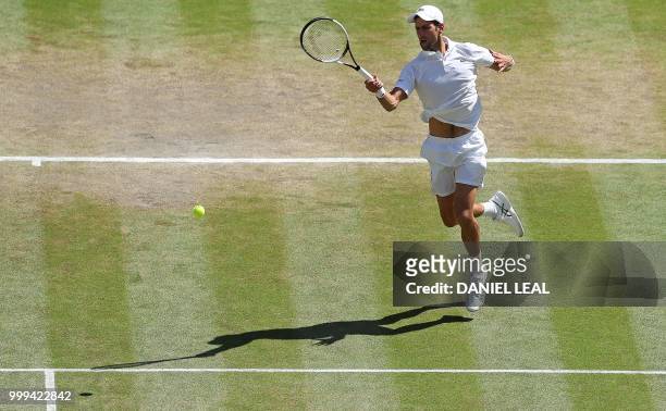 Serbia's Novak Djokovic returns to South Africa's Kevin Anderson in their men's singles final match on the thirteenth day of the 2018 Wimbledon...