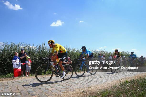 Greg Van Avermaet of Belgium and BMC Racing Team is seen in action wearing the yellow leader jersey during the cobblestones sector between Tilloy and...