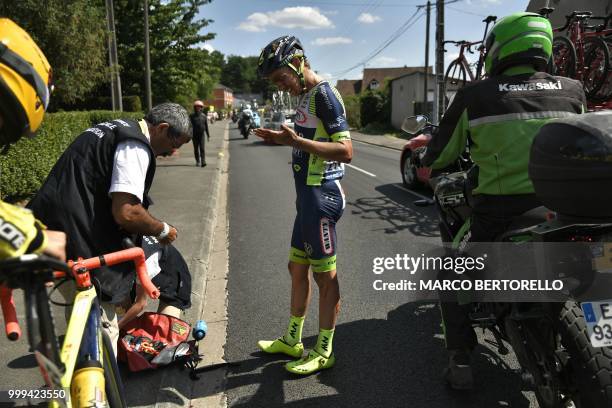 New Zealand's Dion Smith checks his left hand after crashing during the ninth stage of the 105th edition of the Tour de France cycling race between...