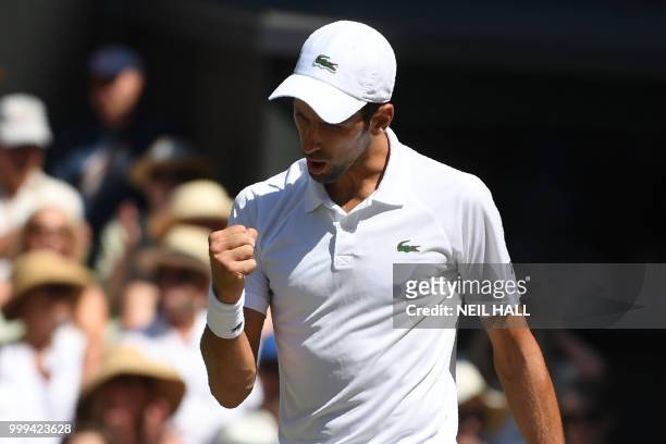 Serbia's Novak Djokovic celebrates taking the first set against South Africa's Kevin Anderson in their men's singles final match on the thirteenth...