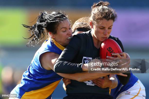 Gabriella Pound of the Blues is tackled during the round 10 VFLW match between Carlton Blues and Williamstown Seagulls at Ikon Park on July 15, 2018...