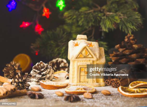 christmas card with little toy house and decorations on a wooden rustic table, selective focus - card table stock pictures, royalty-free photos & images