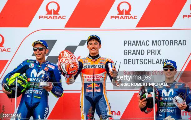 Second placed Italian Yamaha rider Valentino Rossi, winner Spanish Honda rider Marc Marquez and third placed Spanish Yamaha rider Maverick Vinales...