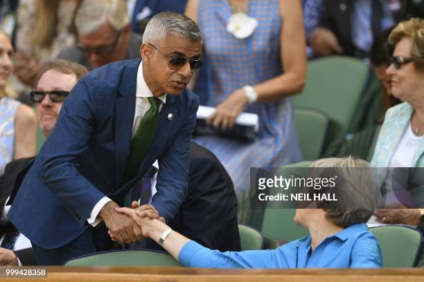 London mayor Sadiq Khan speaks with Britain's Prime Minister Theresa May in the Royal Box before South Africa's Kevin Anderson plays Serbia's Novak...