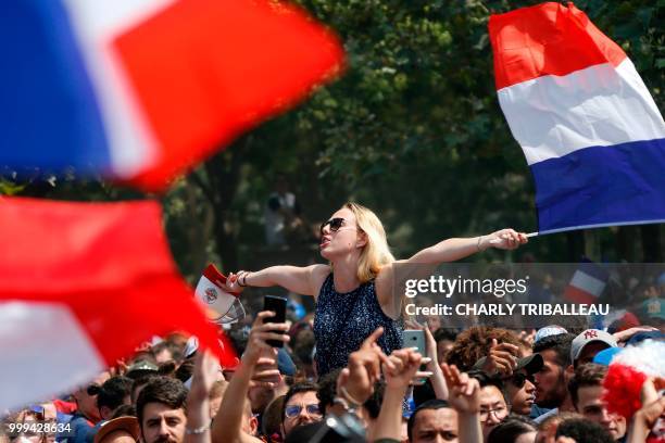 France supporters wave French flags as they gather on the fan zone to watch the Russia 2018 World Cup final football match between France and...