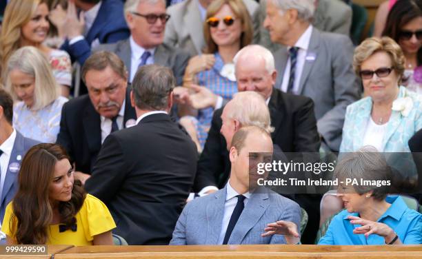 The Duke and Duchess of Cambridge and Theresa May in the royal box on centre court on day thirteen of the Wimbledon Championships at the All England...