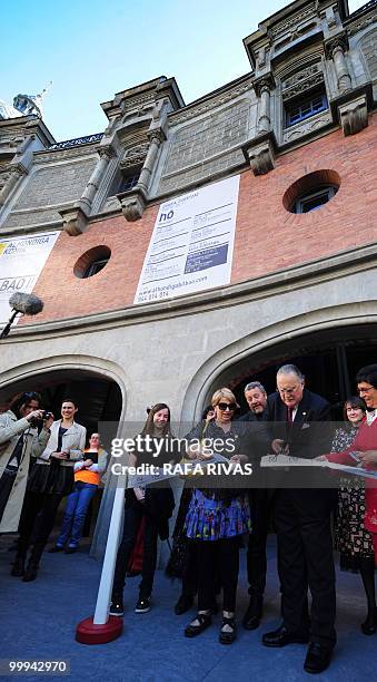 Mayor of Bilbao Inaki Azkuna cuts a band as French architect Philippe Starck looks during the inauguration of the new cultural center the...