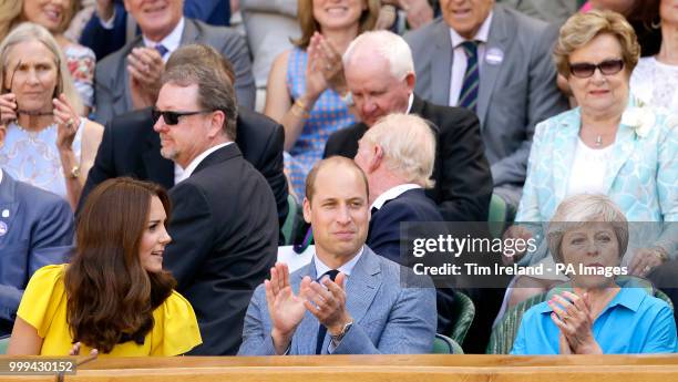 The Duke and Duchess of Cambridge and Theresa May in the royal box on centre court on day thirteen of the Wimbledon Championships at the All England...