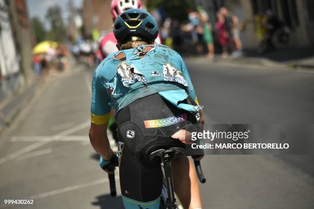 Denmark's Michael Valgren, his ripped jersey after a crash, rides during the ninth stage of the 105th edition of the Tour de France cycling race...