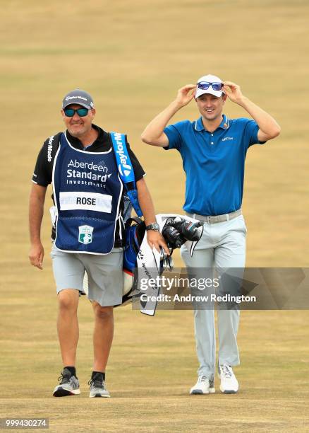 Justin Rose of England walks with his caddy on hole four during day four of the Aberdeen Standard Investments Scottish Open at Gullane Golf Course on...