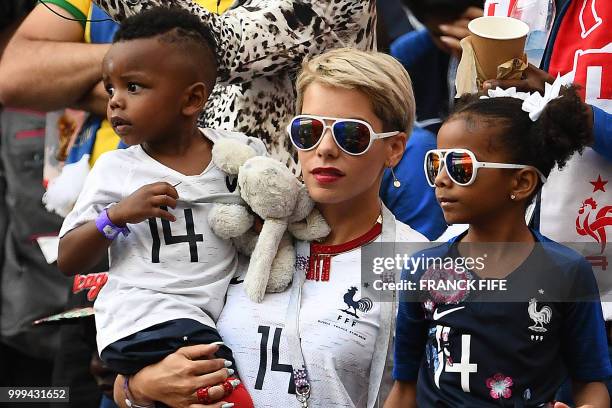 The wife of France's midfielder Blaise Matuidi, Isabelle, and her children wait for the start of the Russia 2018 World Cup final football match...