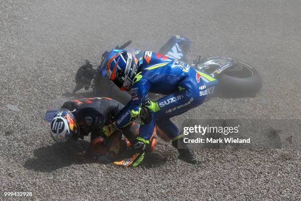 Alex Rins of Spain and Team Suzuki Ecstar reacts after crashing with Pol Espargaro of Spain and Red Bull KTM Team during the MotoGP of Germany at...