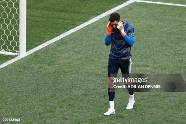 France's goalkeeper Hugo Lloris take part in a warm up session prior to the Russia 2018 World Cup final football match between France and Croatia at...