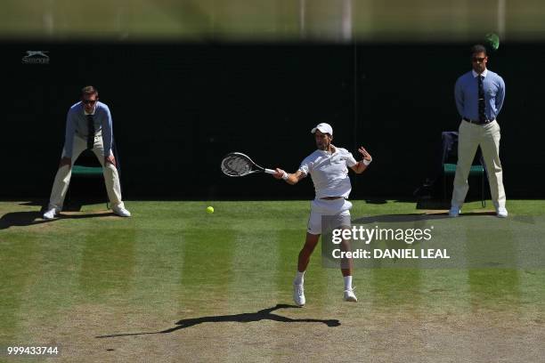 Serbia's Novak Djokovic returns to South Africa's Kevin Anderson in their men's singles final match on the thirteenth day of the 2018 Wimbledon...